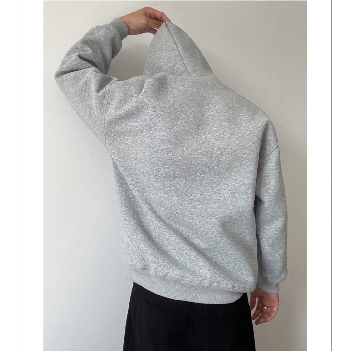 Side view of a men's long sleeve loose fit hoodie