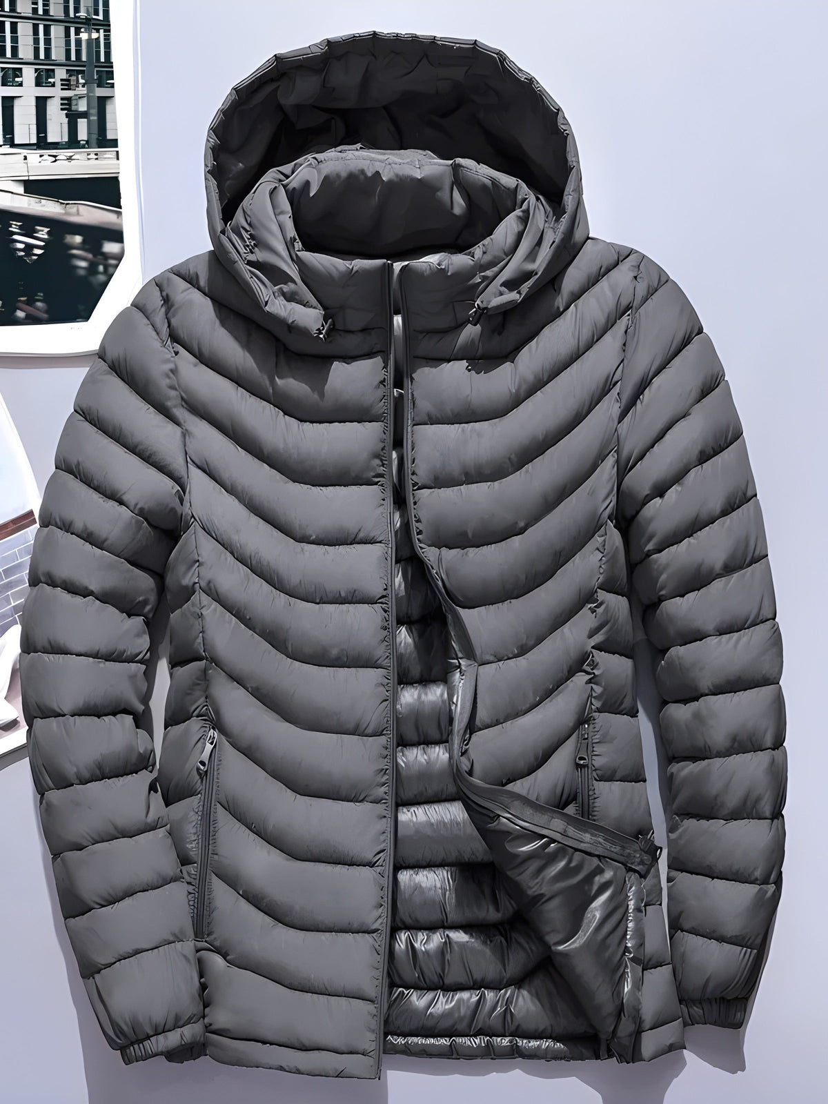 Quilted men's jacket with practical pockets and attached hood