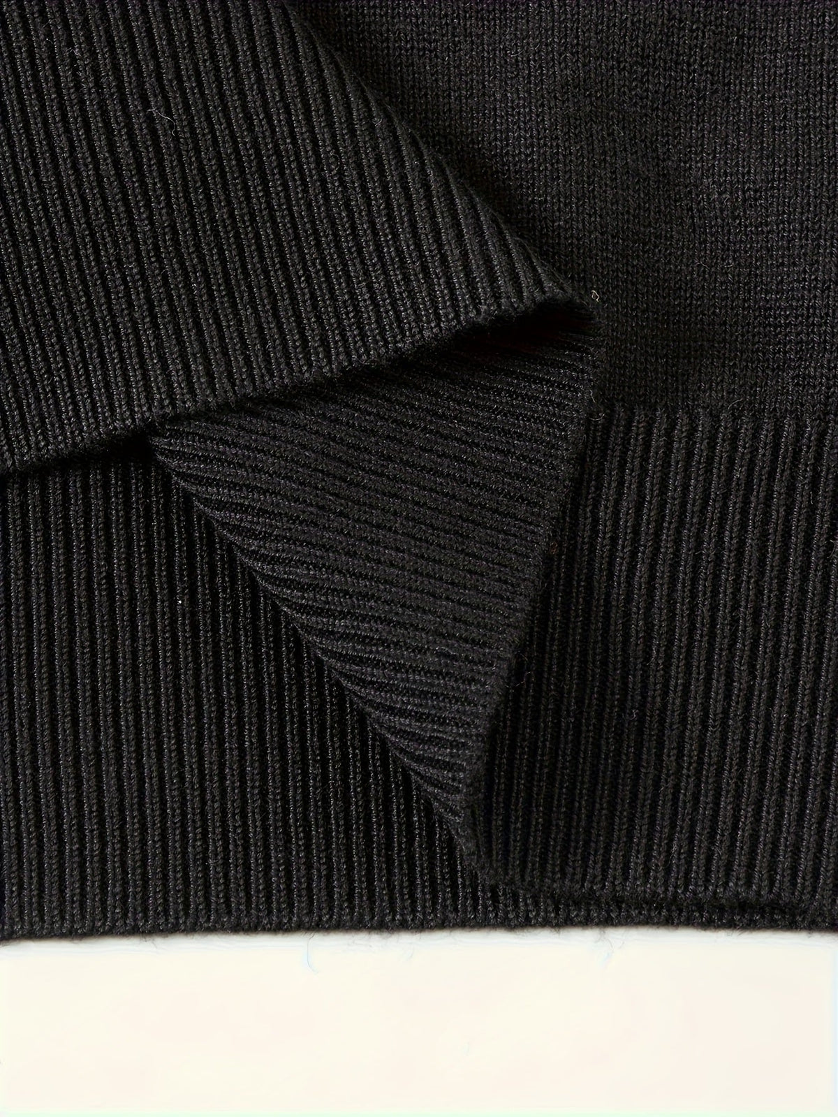 Detail of the hem on a men's knit polo sweater
