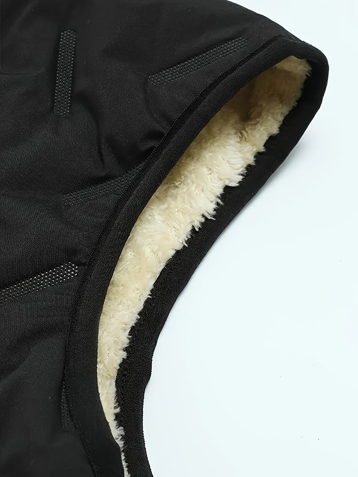Close-up of the vest's stand collar and quilted construction