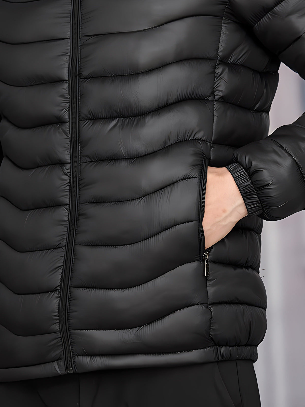 Back view of a lightweight hooded jacket with quilted panels