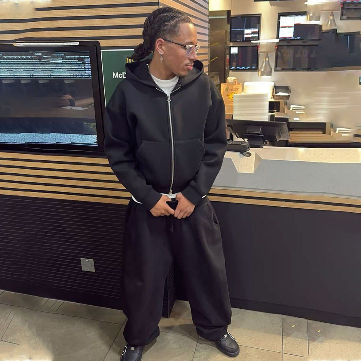 Relaxed-fit sweatpants paired with a men's zip hoodie