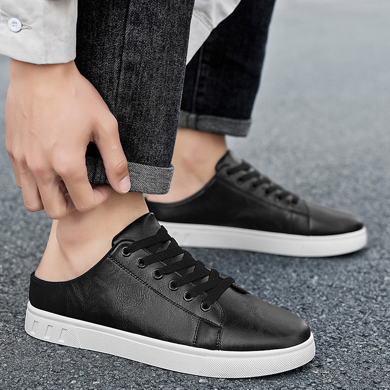 Angled view of casual leather sneakers with open-back mule styling