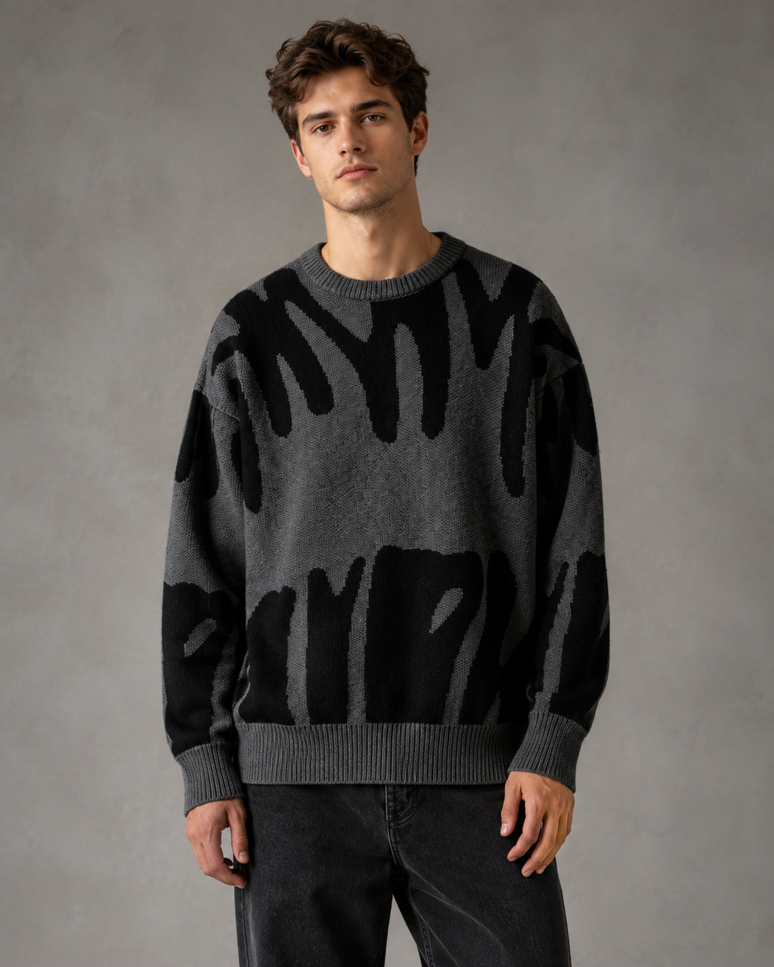 Abstract knit drop shoulder sweater displayed for a men's fashion look