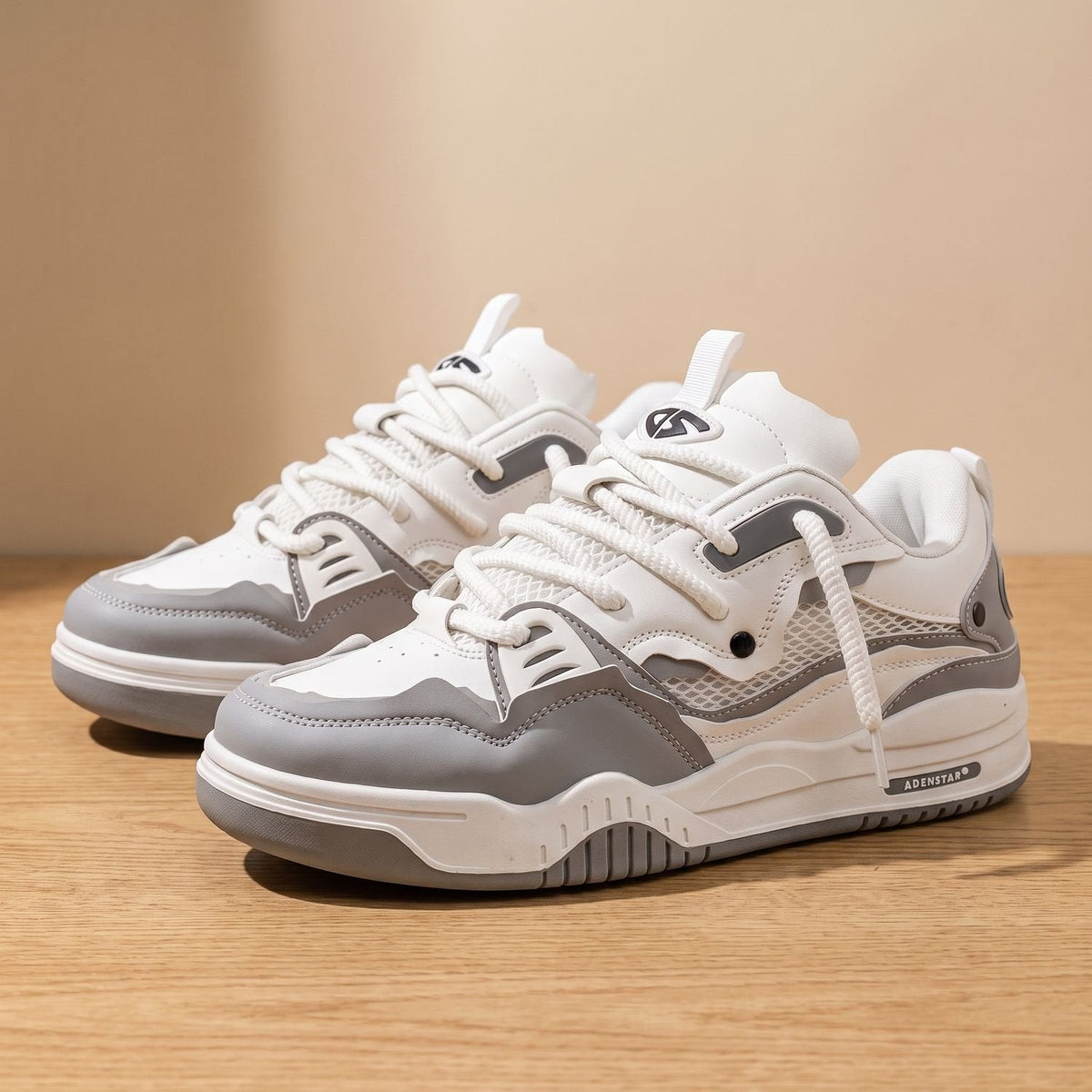Men's white and gray sneakers with textured soles and padded collars