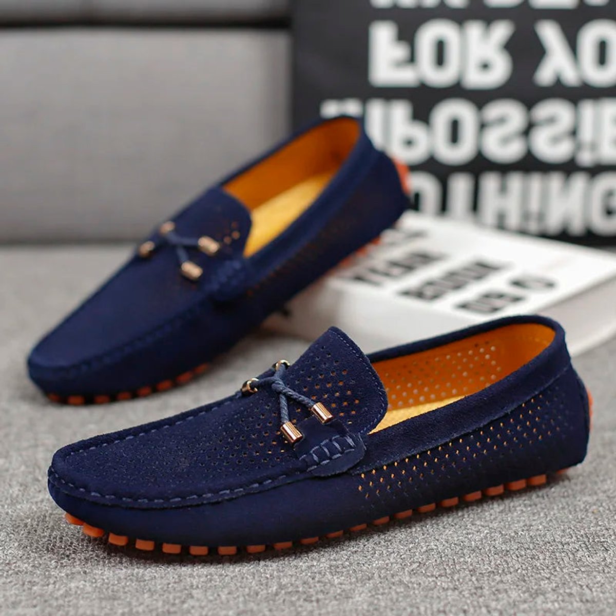 Detailed view of the suede upper and perforations on a driving loafer
