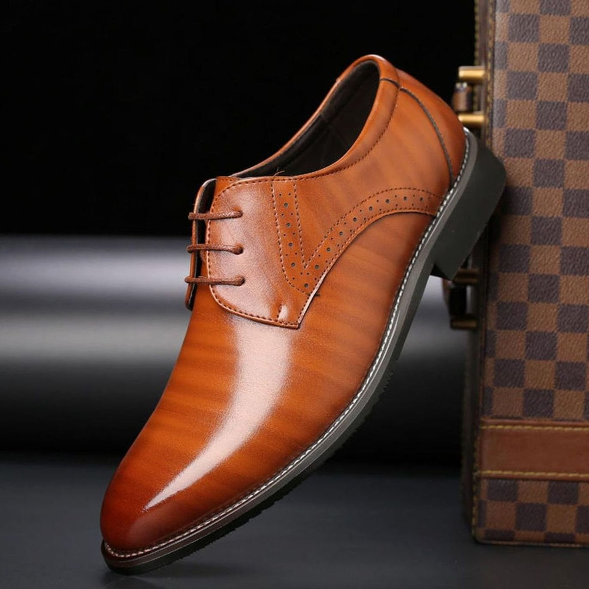 Men's leather dress shoes featuring a secure lace-up closure and brogue styling