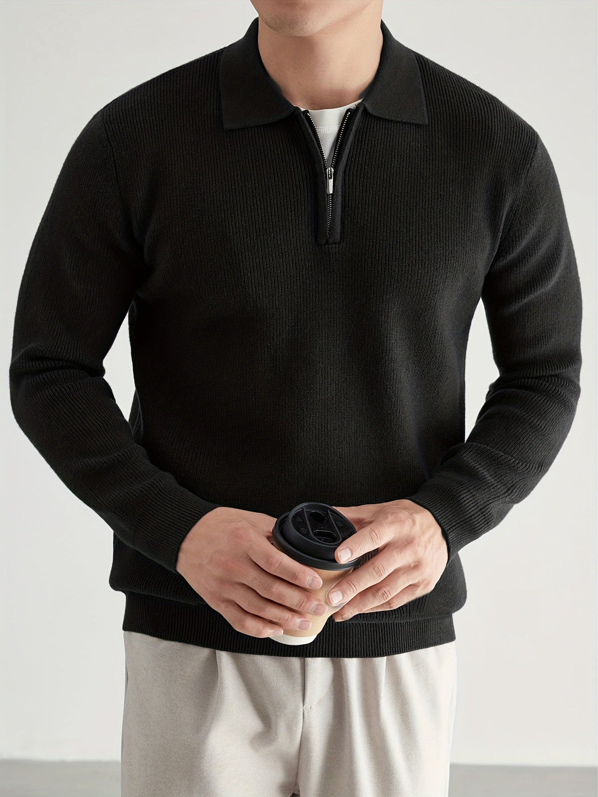 Side view of a men's quarter-zip polo sweater