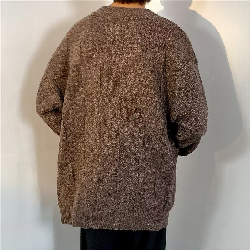Men's long sleeve sweater displayed with its diamond pattern design