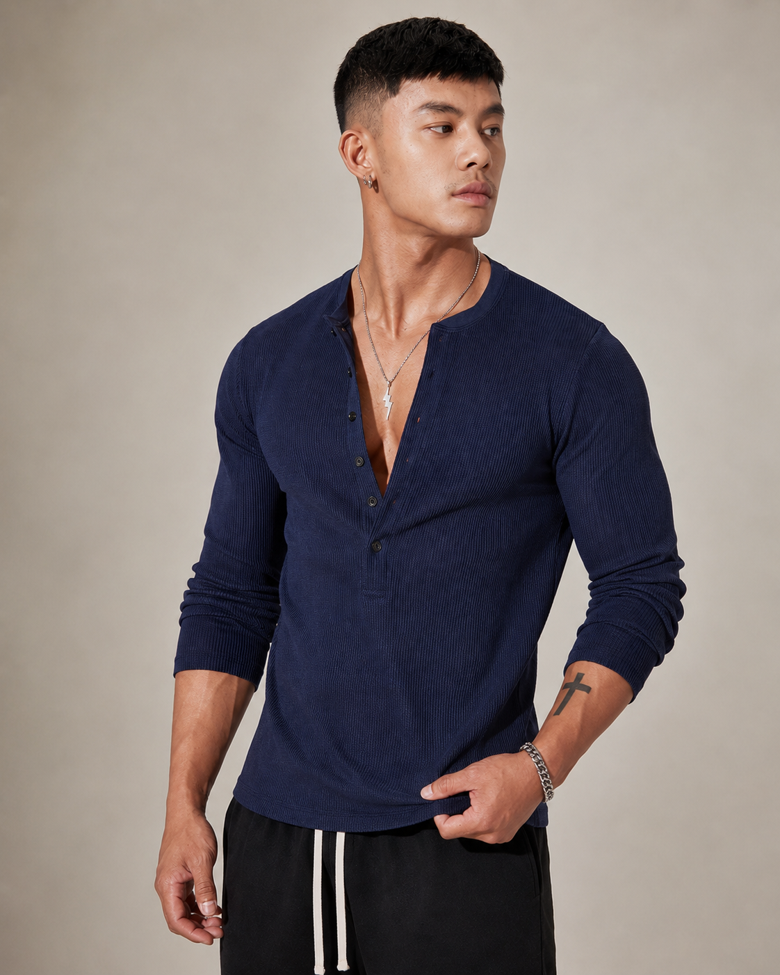 Half-button placket detail on a ribbed knit sweater