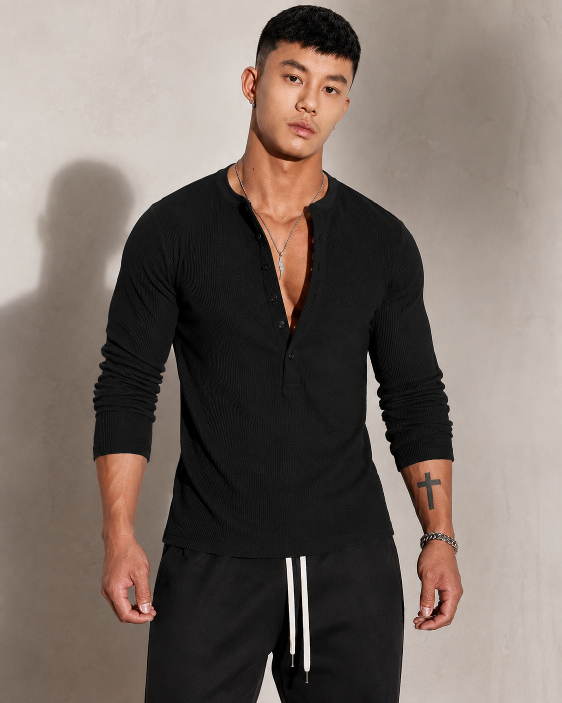 Close-up of the ribbed knit texture and button neckline