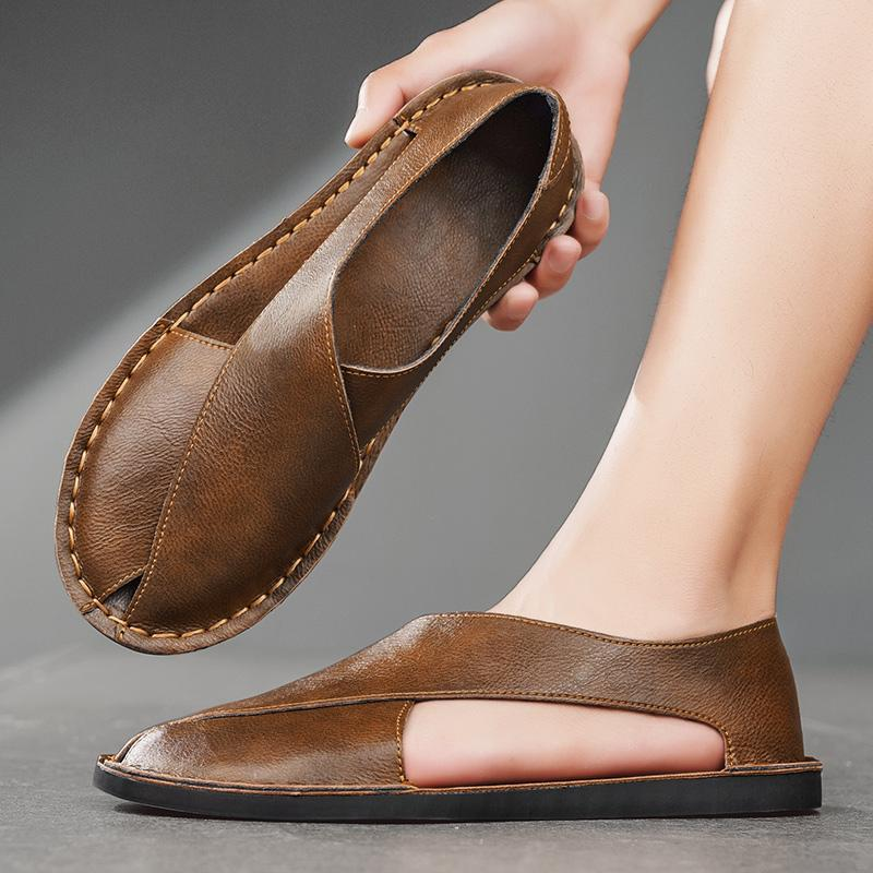 Detailed view of leather stitching on crossover flat sandals
