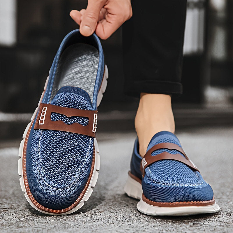 Angled view of penny loafers highlighting the leather trim