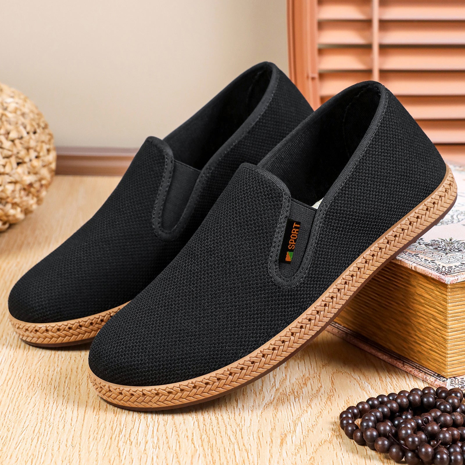 Pair of men's casual slip-on shoes showing the woven knit texture
