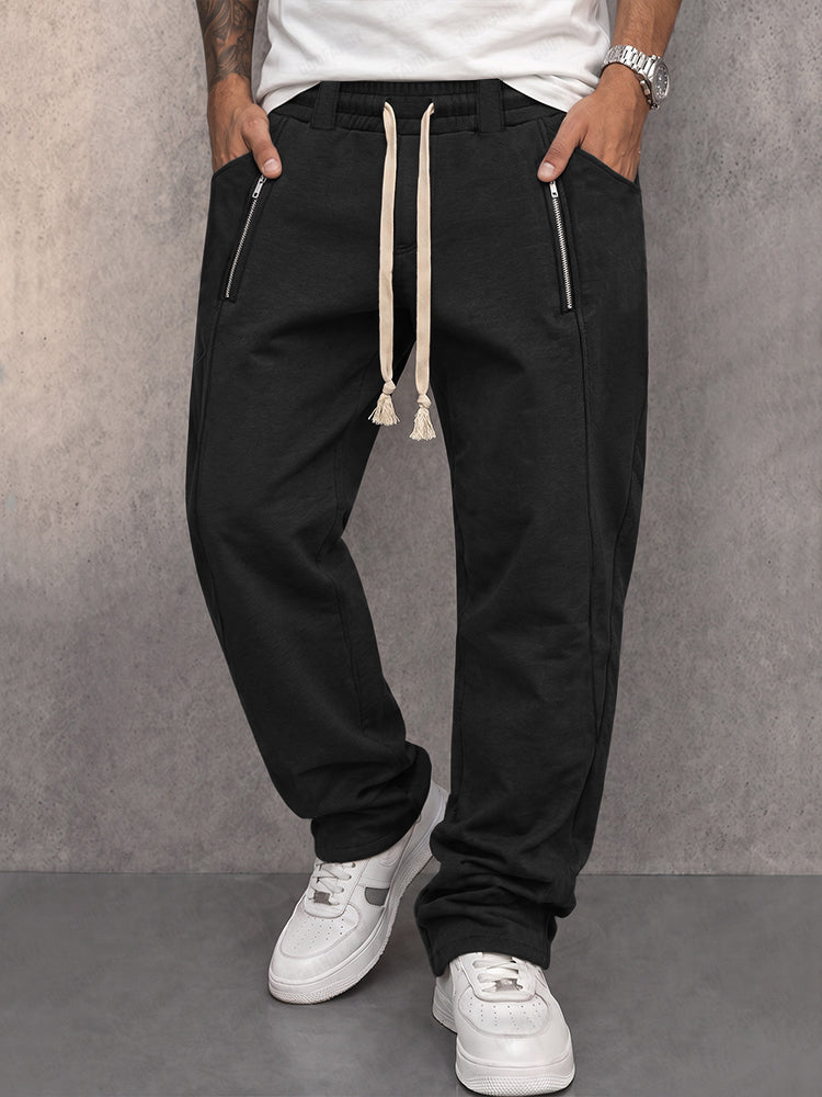 Athleisure sweatpants with zipper accents shown from the front