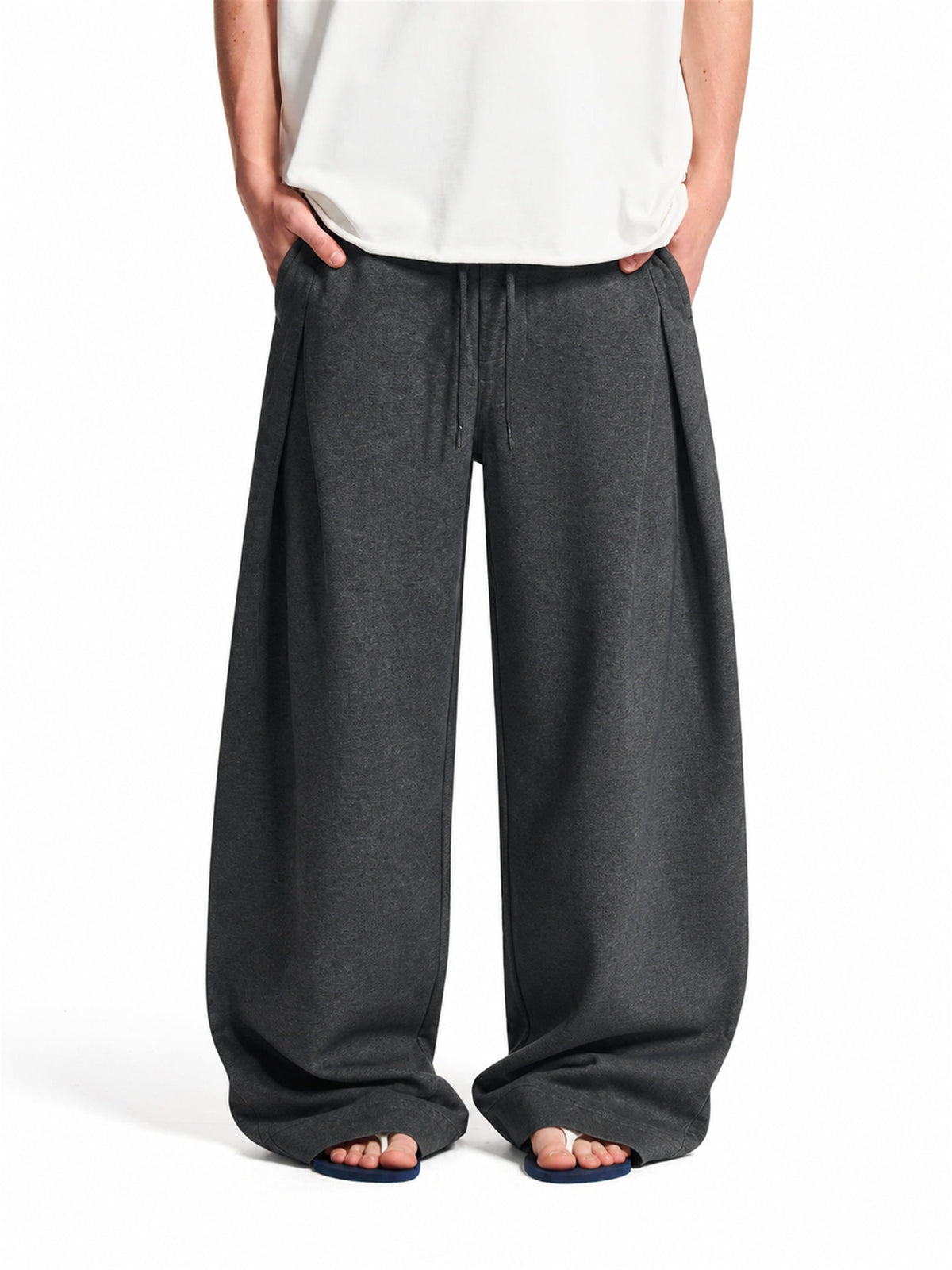 Pleated baggy sweatpants shown from the front with a relaxed silhouette