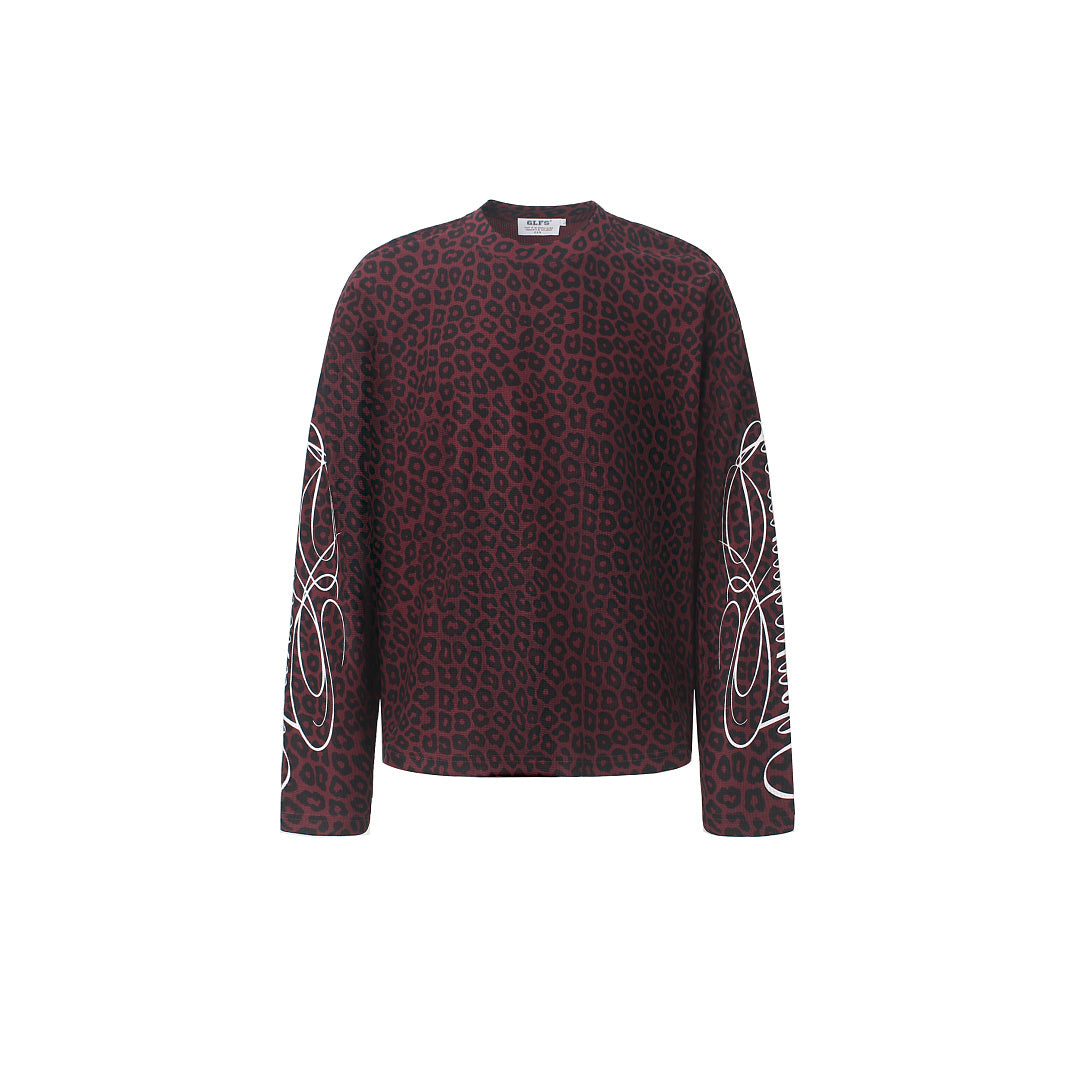 Close-up of embroidered sleeve detail on a leopard print sweatshirt