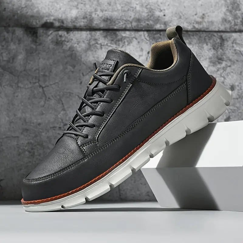 Pair of men's minimalist sneakers displayed side by side