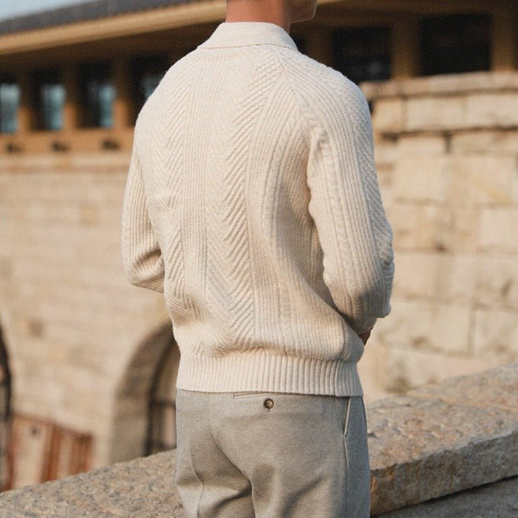 Detailed view of the textured knit fabric on a men's button collar sweater