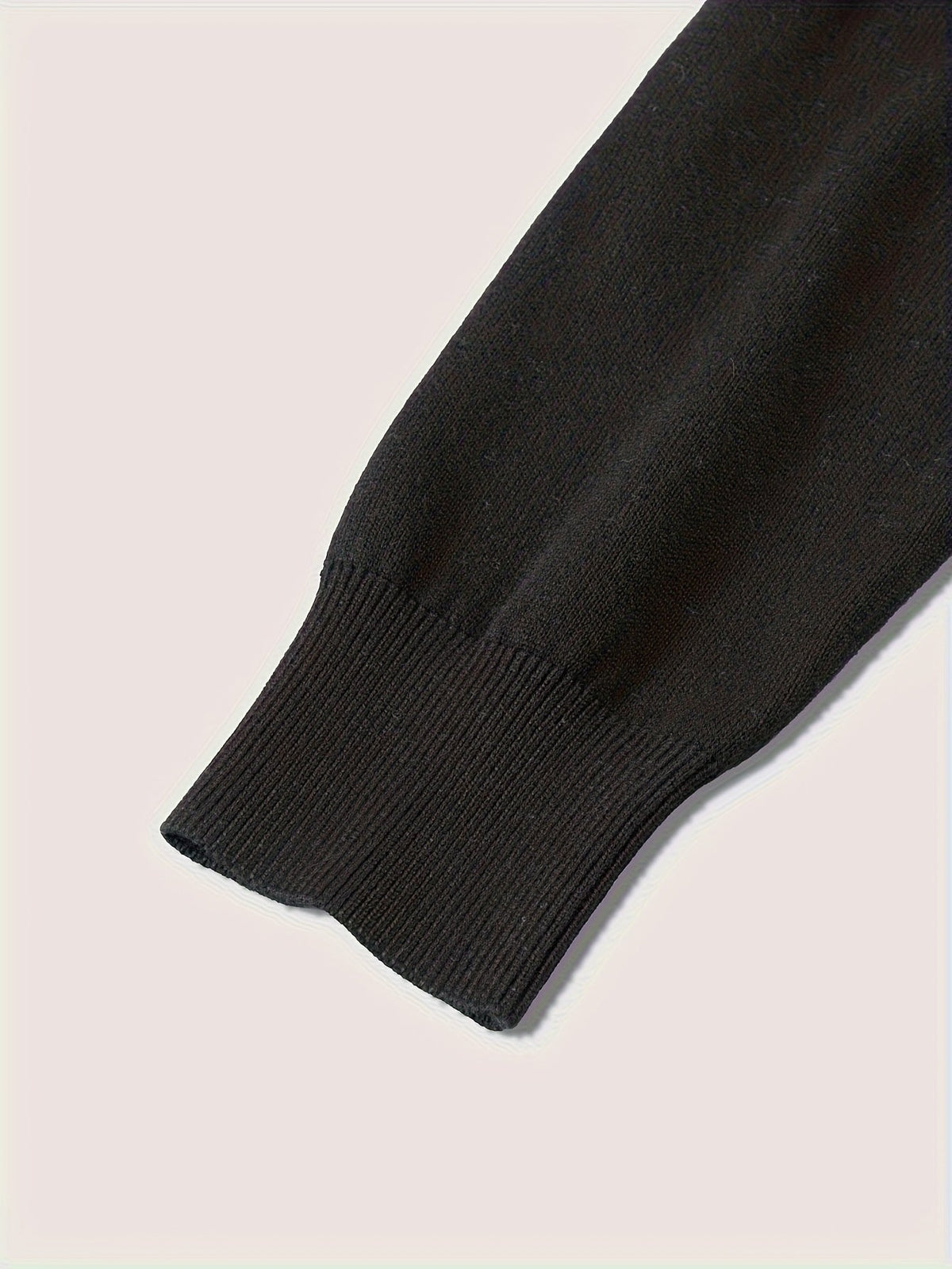 Detail of the ribbed cuffs on a quarter-zip knit sweater