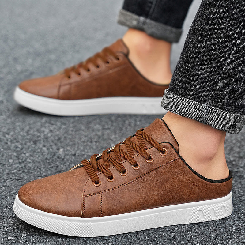 Front view of mule sneakers with a rounded toe and white sole
