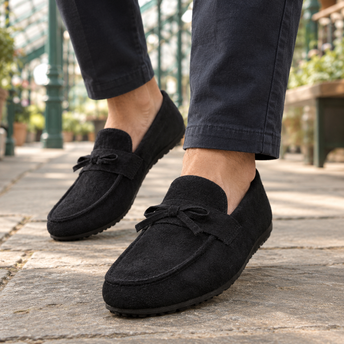 Women's suede slip-on loafer featuring a delicate bow detail
