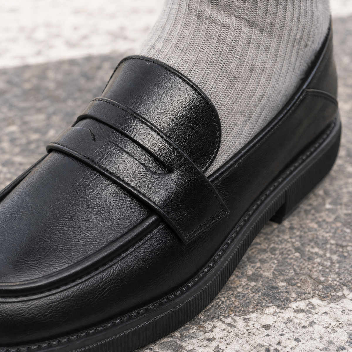 Pair of casual penny strap loafers shown from the side