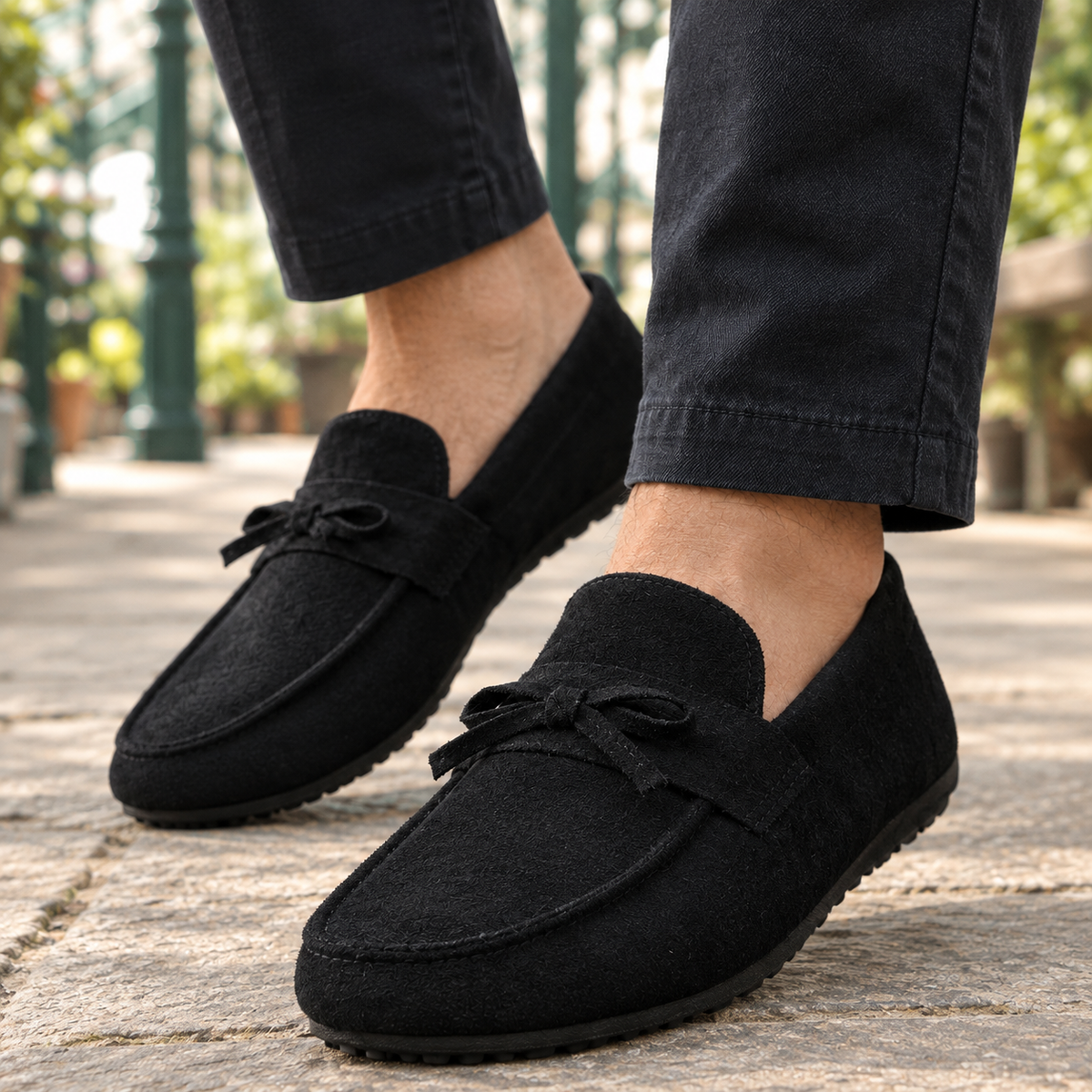 Side view of a women's suede loafer with a slip-on design