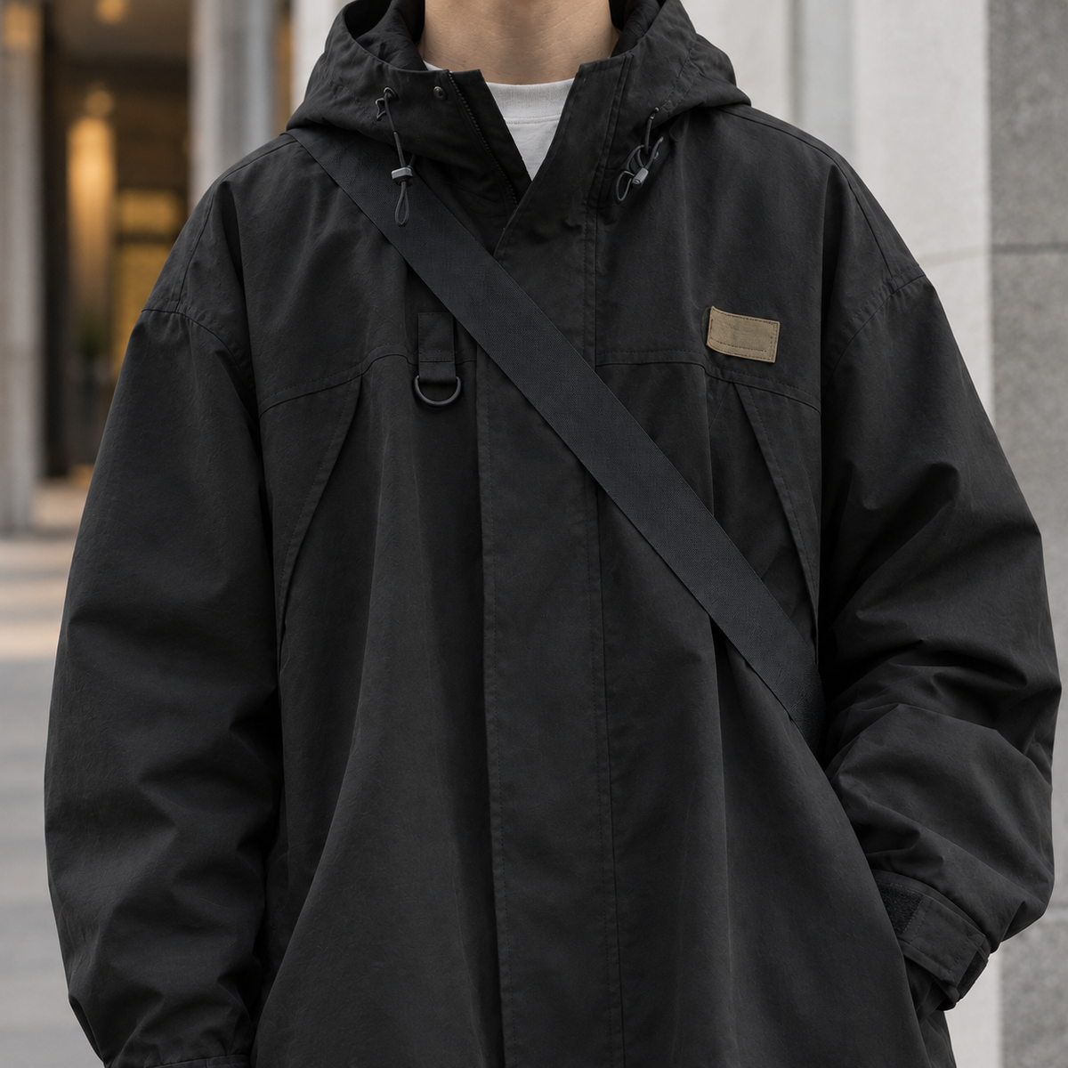 Men's hooded woven jacket featuring a practical hood and clean woven design