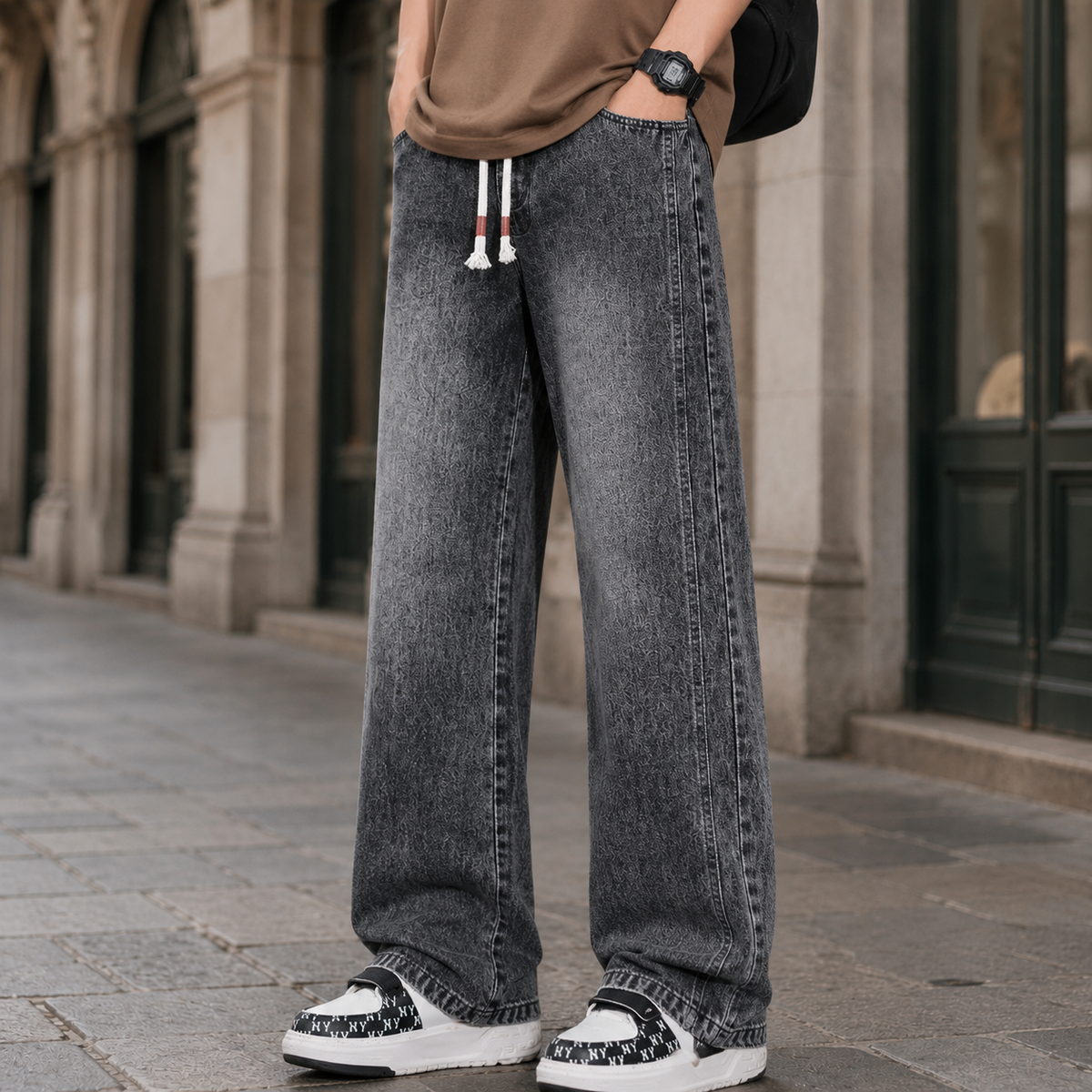 Close-up of the waistband and front pockets on relaxed wide leg jeans