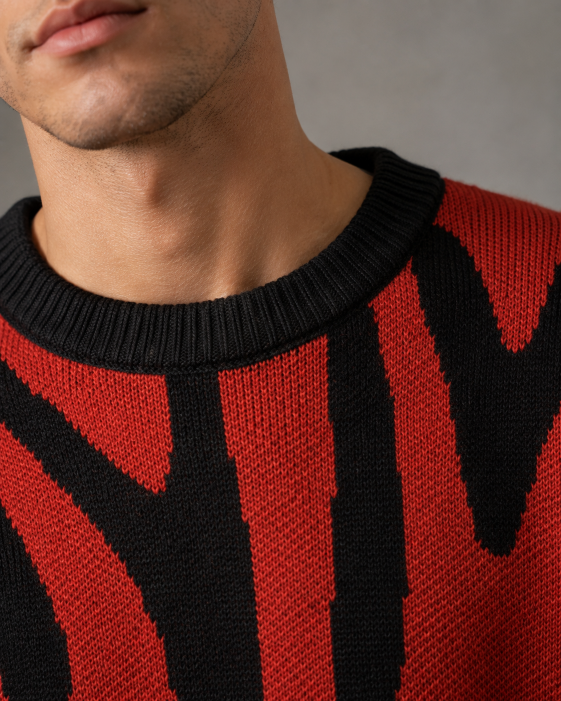 Side view of a men's drop shoulder abstract knit sweater