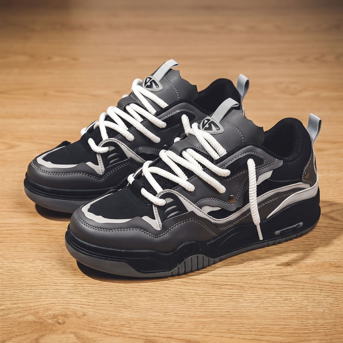 Side view of men's low-top lace-up sneakers in white and gray