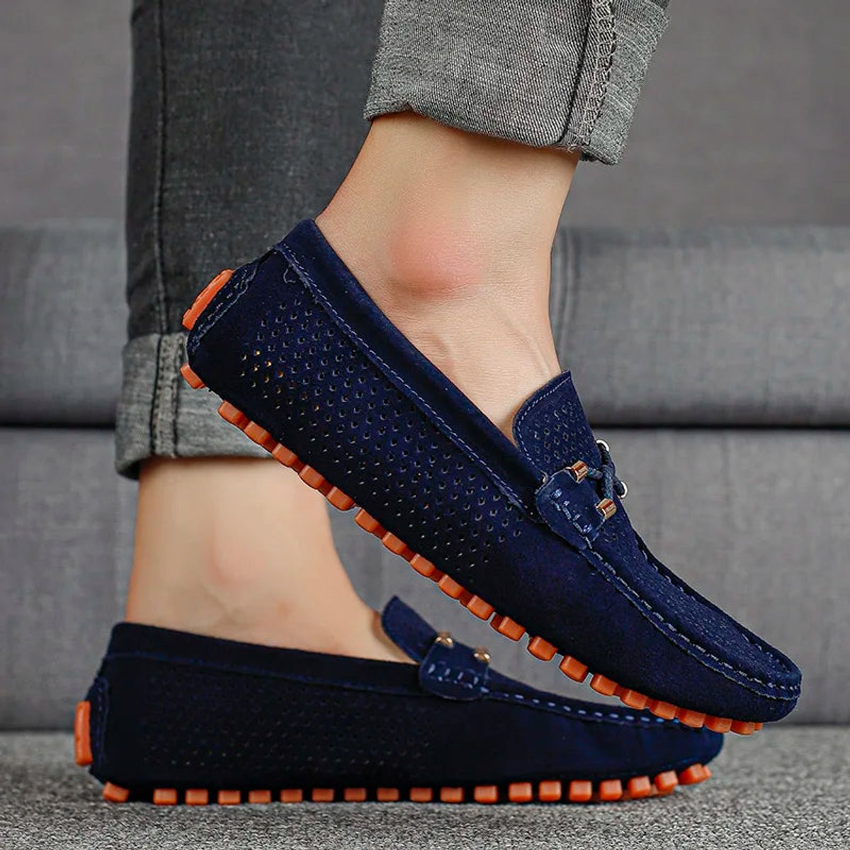 Pair of men's perforated suede driving loafers viewed from above