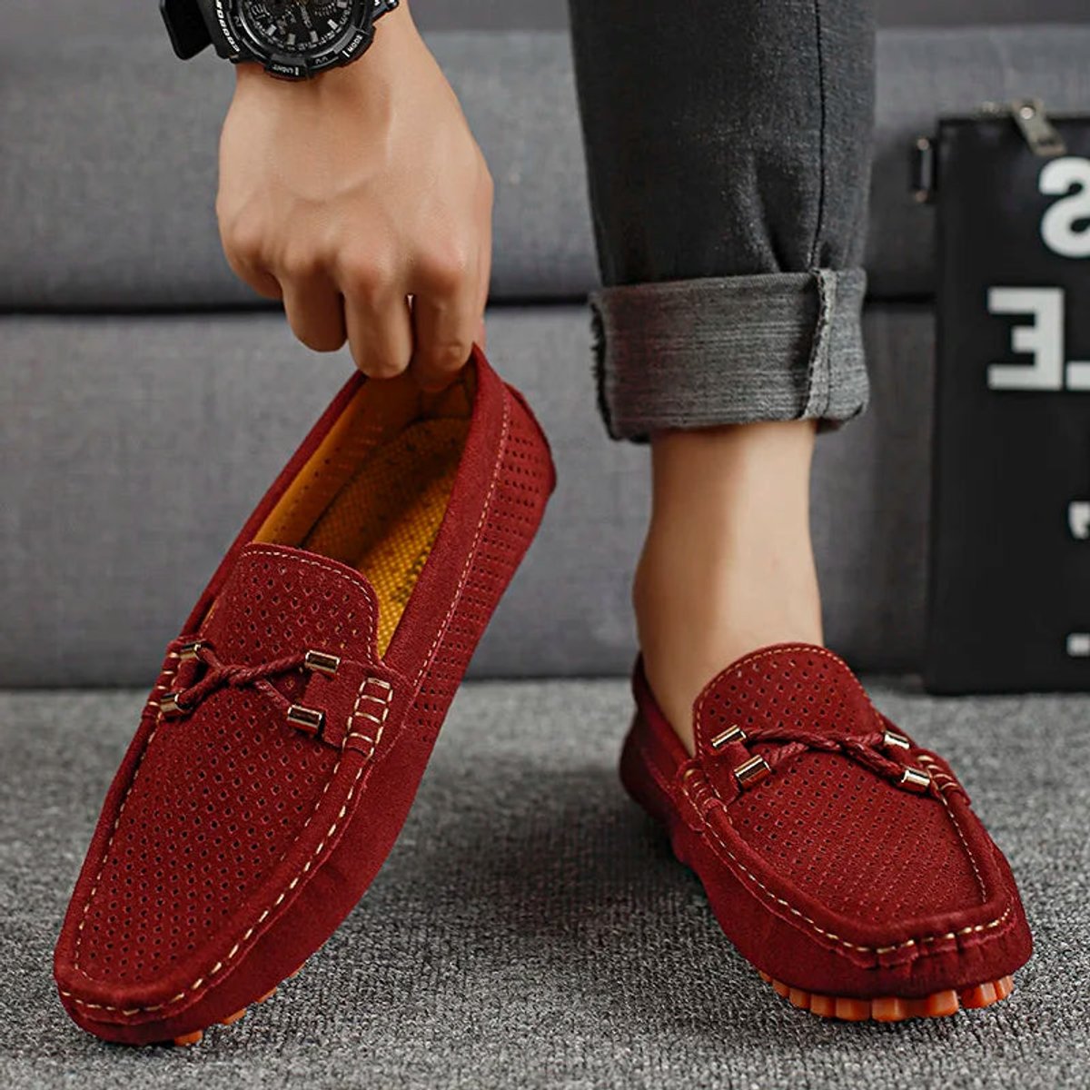 Close-up of perforated suede detailing on a men's driving loafer