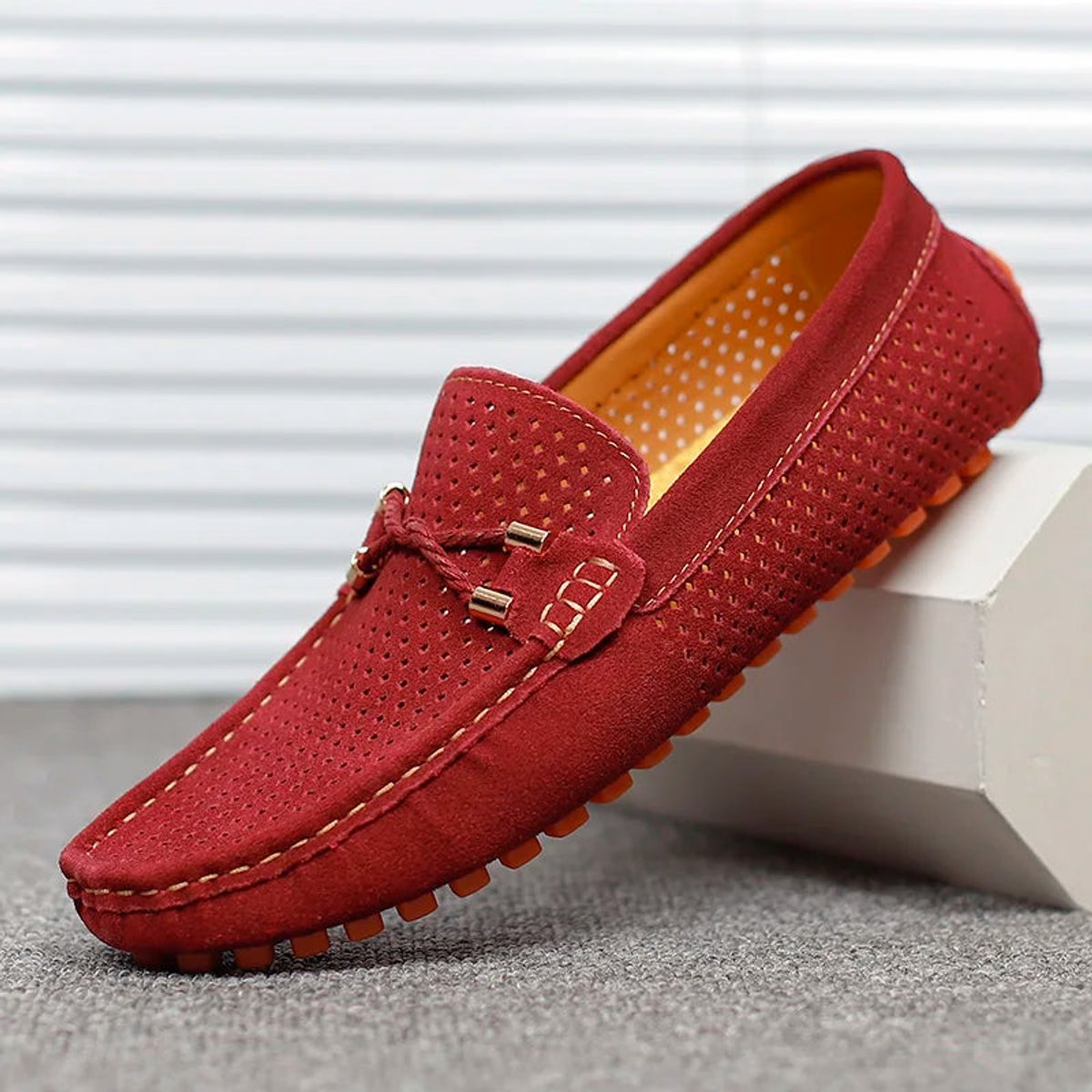 Close-up of the textured driving sole on a men's suede loafer