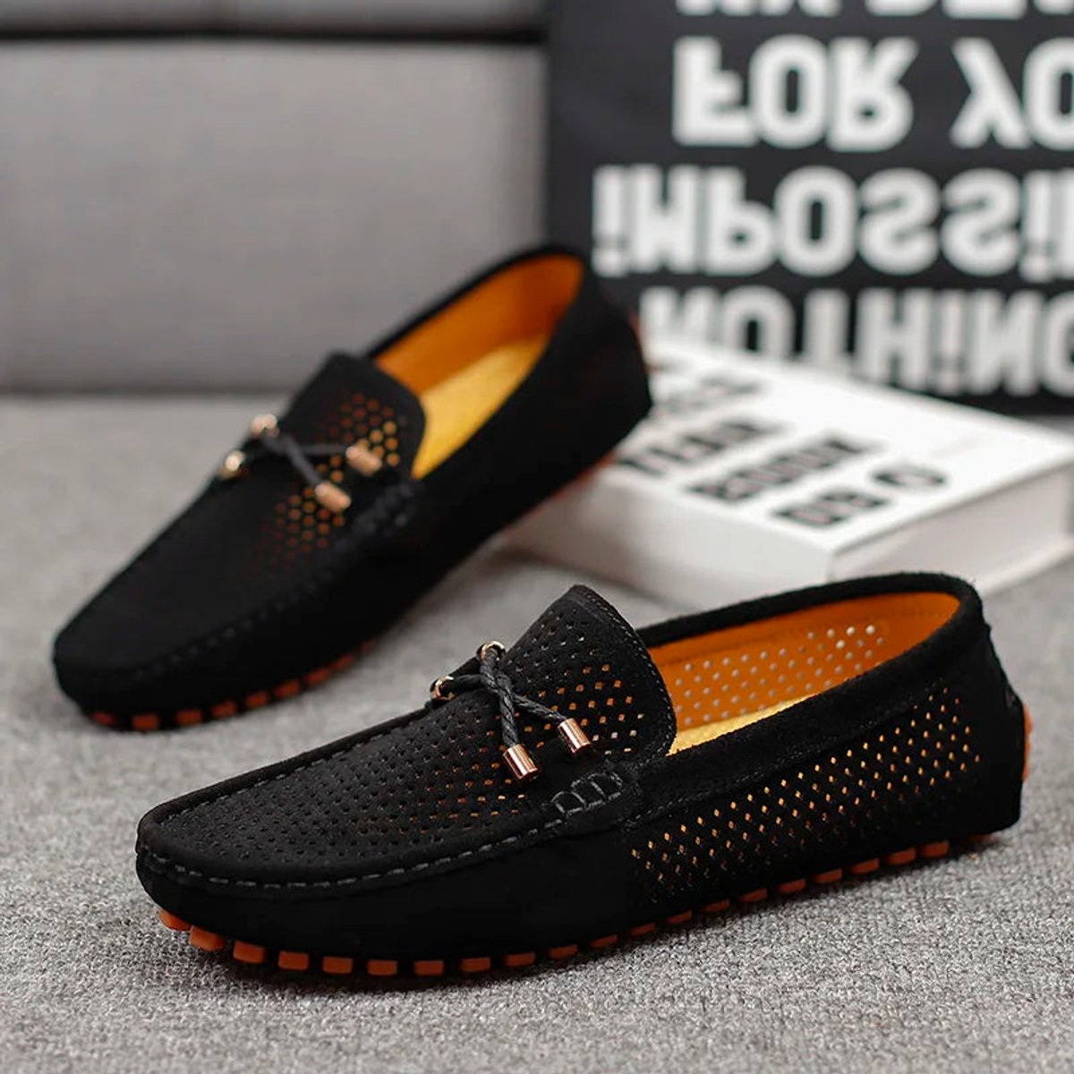 Men's perforated suede loafers shown at a three-quarter angle