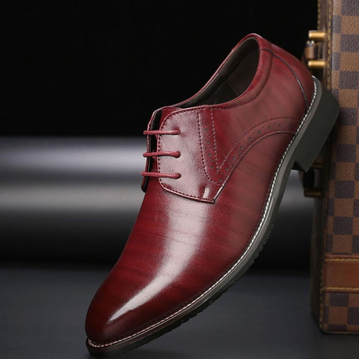 Pair of polished leather brogue shoes displayed from above